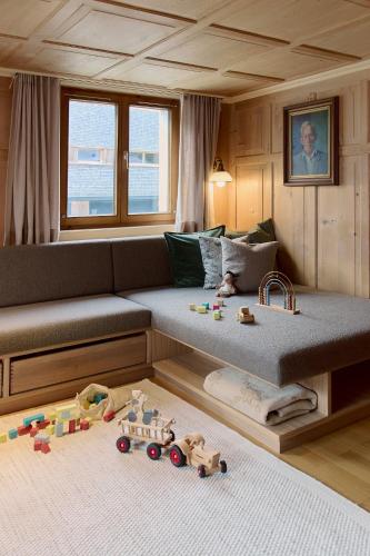 a living room with a couch with toys on the floor at Ferienhaus Mell Aroma in Mellau