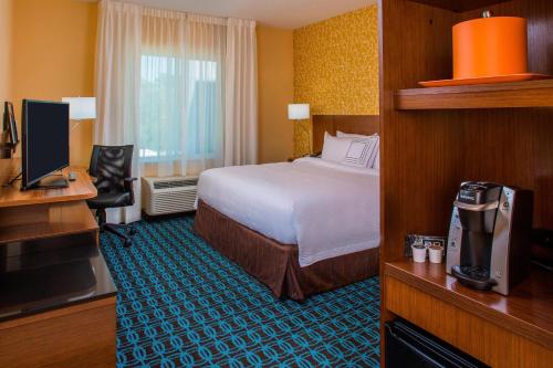 a hotel room with a bed and a desk at Fairfield Inn & Suites by Marriott Cut Off-Galliano in Galliano