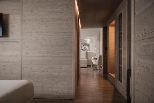 a hallway leading to a bedroom with white walls at Miramonti Park Hotel in Bormio