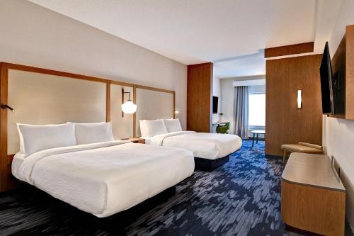 a hotel room with two beds and a desk at Fairfield Inn & Suites by Marriott Selinsgrove in Selinsgrove