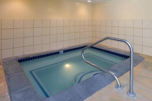 a bath tub with a hand rail in a bathroom at Fairfield Inn Salt Lake City Layton in Layton