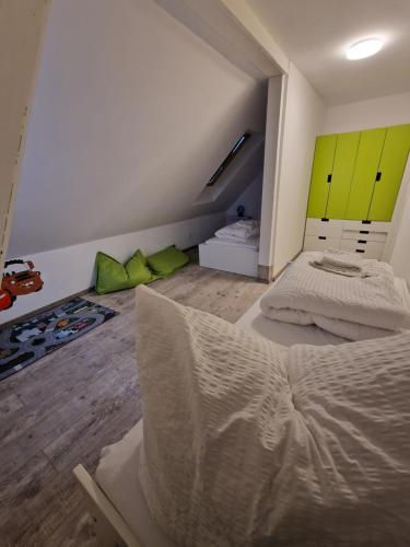 a bedroom with two beds and green cabinets at Mikes Fewo in Hohegeiß