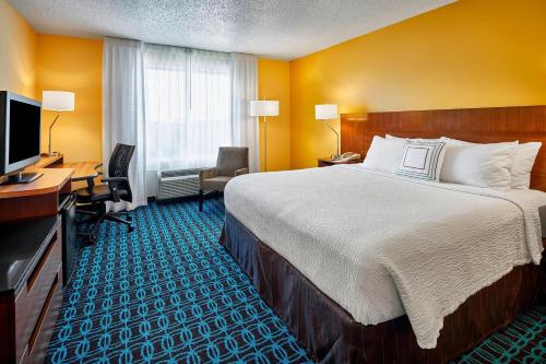 a hotel room with a bed and a desk and a television at Fairfield Inn Myrtle Beach Broadway at the Beach in Myrtle Beach