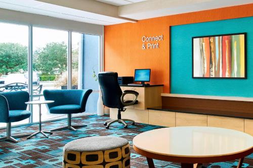 a waiting room with chairs and a table and a desk at Fairfield Inn Myrtle Beach Broadway at the Beach in Myrtle Beach