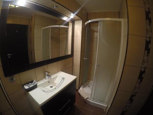 a bathroom with a sink and a shower at Princess Butique in Poiana Brasov