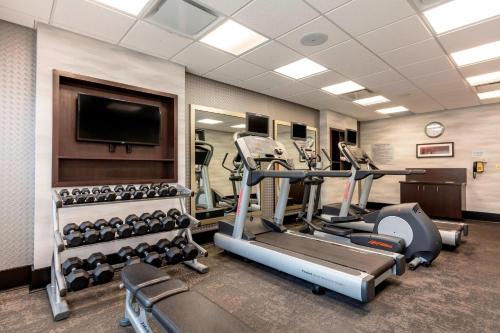 a gym with cardio equipment and a flat screen tv at Fairfield Inn & Suites Columbus in Columbus