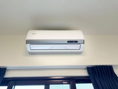 a printer is on the ceiling of a room at 碧雲香榭羅東包棟民宿 in Luodong
