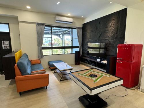a living room with a red refrigerator and a table at 碧雲香榭羅東包棟民宿 in Luodong