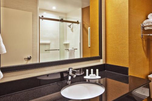 a bathroom with a sink and a mirror at Fairfield Inn & Suites by Marriott Plattsburgh in Plattsburgh