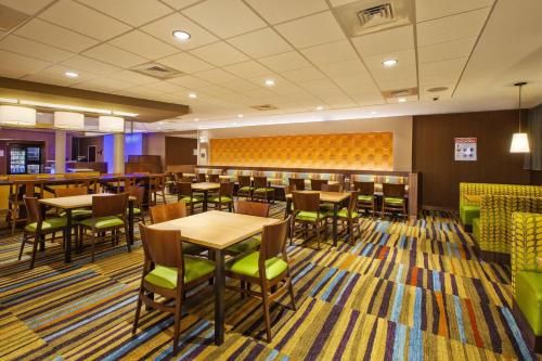 a dining room with tables and chairs in a restaurant at Fairfield Inn & Suites by Marriott Plattsburgh in Plattsburgh