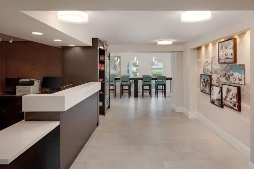 an office lobby with a waiting room with a table at Fairfield Inn and Suites by Marriott Palm Beach in Palm Beach