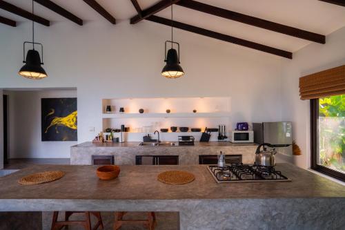 a kitchen with a large island in a room at Lunar Villas Koh Tao - Luxury Private Pool Villas in Koh Tao