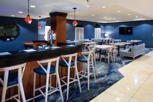 a bar in a restaurant with blue walls and stools at Fairfield Inn & Suites Santa Cruz - Capitola in Capitola