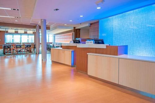 an office lobby with a reception desk and tables at Fairfield Inn & Suites by Marriott LaPlace in Laplace