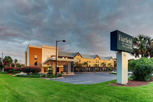 a sign for a hotel in front of a parking lot at Fairfield Inn & Suites Southport in Southport