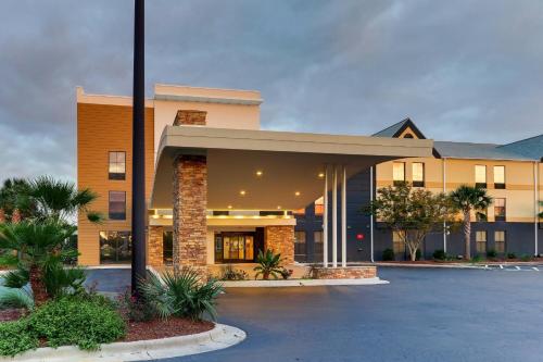 a building with a parking lot in front of it at Fairfield Inn & Suites Southport in Southport