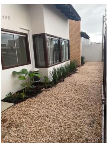 a house with a gravel driveway next to a building at Casa Sinop in Sinop