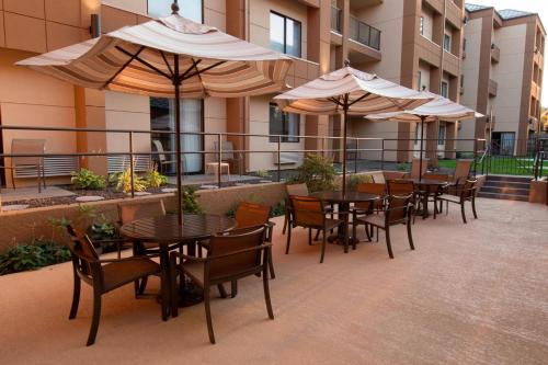 a patio with tables and chairs and umbrellas at Fairfield Inn & Suites by Marriott Spokane Valley in Spokane Valley
