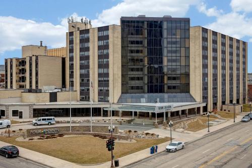 a large building with cars parked in front of it at Four Points by Sheraton Peoria in Peoria