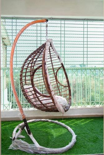a basket swing hanging from a window at Teju's Nest in Badlapur