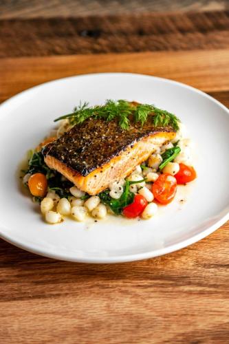 a plate of food with fish and vegetables on a table at Four Points by Sheraton Peoria in Peoria