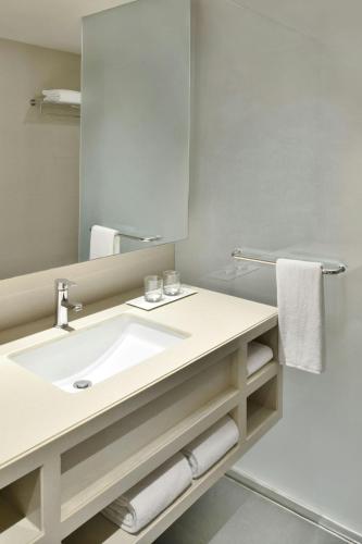a bathroom with a sink and a mirror at Fairfield by Marriott Hyderabad Gachibowli in Hyderabad