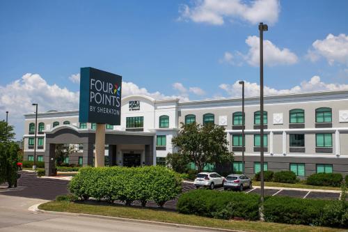 a large white building with a sign in front of it at Four Points by Sheraton Appleton in Appleton