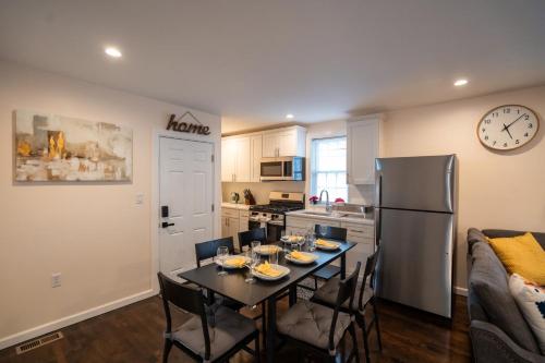 a kitchen and dining room with a table and a refrigerator at 30-1 - 4BR Boston - Cozy Apt near Geneva Cliffs in Boston