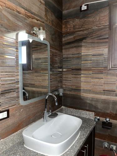 a bathroom with a sink and a mirror at Furnished apartment - Madinaty in Madinaty