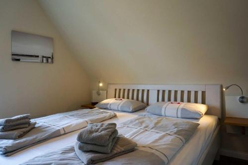 a bedroom with two beds with towels on them at Ferienhaus-Min-Drom in Sankt Peter-Ording