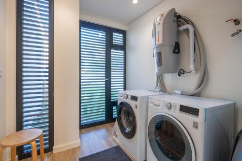 a laundry room with a washer and dryer at Waterfall View in Paradise in Louredo