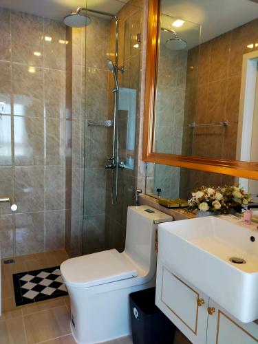 a bathroom with a toilet and a sink and a shower at The Empire Tower Jomtien KZi 2205 in Jomtien Beach