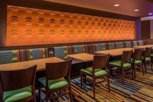 a row of tables and chairs in a restaurant at Fairfield Inn & Suites by Marriott St. Louis Westport in Maryland Heights