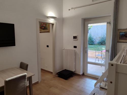 a living room with a table and a sliding glass door at Villa don peppe in Selva di Fasano