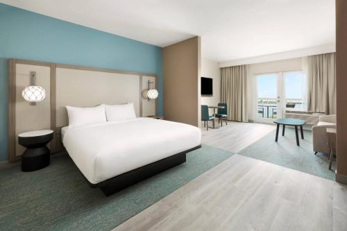 a hotel room with a bed and a living room at Fairfield by Marriott Inn & Suites Marathon Florida Keys in Marathon