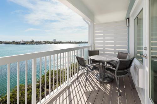 a balcony with a table and chairs and a view of the water at Fairfield by Marriott Inn & Suites Marathon Florida Keys in Marathon
