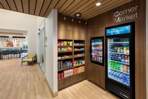 a store aisle with a cooler and a counter with drinks at Fairfield by Marriott Inn & Suites Marathon Florida Keys in Marathon