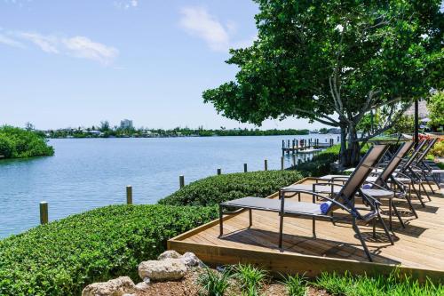 a group of lounge chairs sitting on a wooden deck by the water at Fairfield by Marriott Inn & Suites Marathon Florida Keys in Marathon