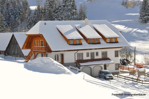 a house with snow on top of it at Ferienhof Hintergrabenbauer in Spital am Pyhrn