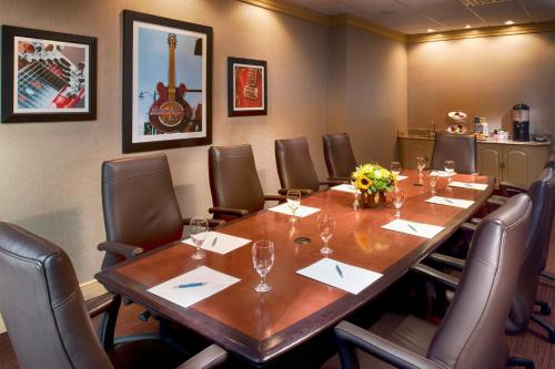 a conference room with a large wooden table and chairs at Four Points by Sheraton Memphis East in Memphis