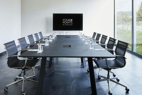 a large conference room with a long table and chairs at Four Points by Sheraton Barcelona Airport in Barcelona
