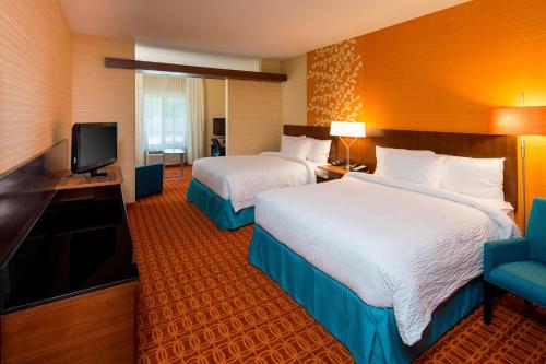 a hotel room with two beds and a flat screen tv at Fairfield Inn & Suites by Marriott Hershey Chocolate Avenue in Hershey