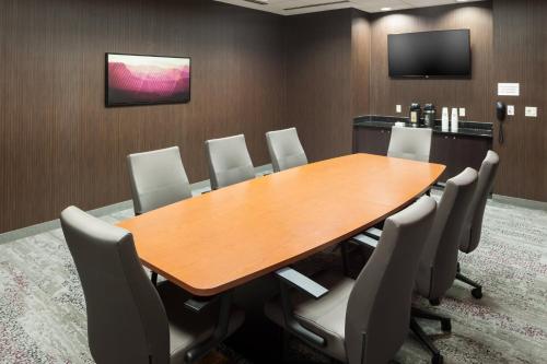 a conference room with a wooden table and chairs at Fairfield Inn and Suites Phoenix Chandler Fashion Center in Chandler