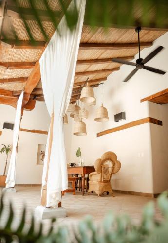 a room with wooden ceilings and a table and chairs at Central Park Luxurious Historical Home With Pool in Granada