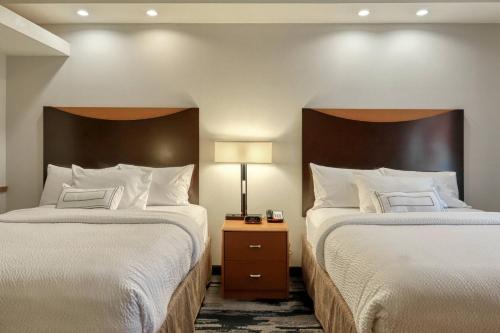 a hotel room with two beds and a lamp at Fairfield Inn & Suites by Marriott Harrisburg West/New Cumberland in New Cumberland