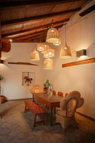 a dining room with a table and chairs and lights at Central Park Luxurious Historical Home With Pool in Granada