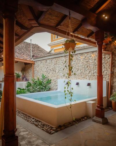 an outdoor hot tub under a pergola at Central Park Luxurious Historical Home With Pool in Granada