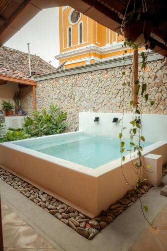 a bathtub in the courtyard of a house at Central Park Luxurious Historical Home With Pool in Granada