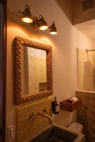 a bathroom with a mirror and a sink at Central Park Luxurious Historical Home With Pool in Granada
