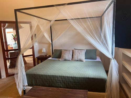 a bedroom with a canopy bed with two pillows at Central Park Luxurious Historical Home With Pool in Granada
